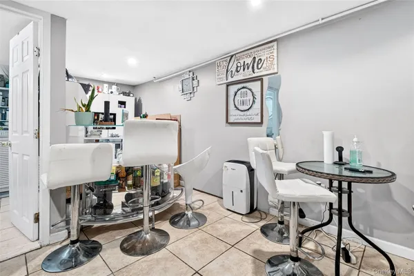 a view of a workspace with furniture and a table