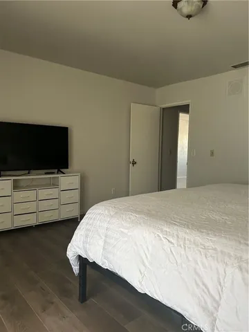 a bedroom with a bed and flat screen tv