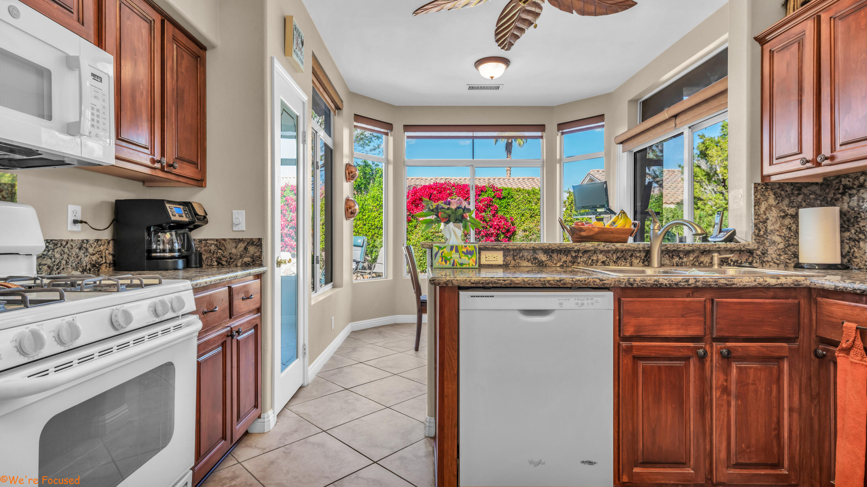 78326 Moongold Road Palm Desert, CA 92211 - Photo 12 of 33 a kitchen with stainless steel appliances granite countertop a sink and cabinets