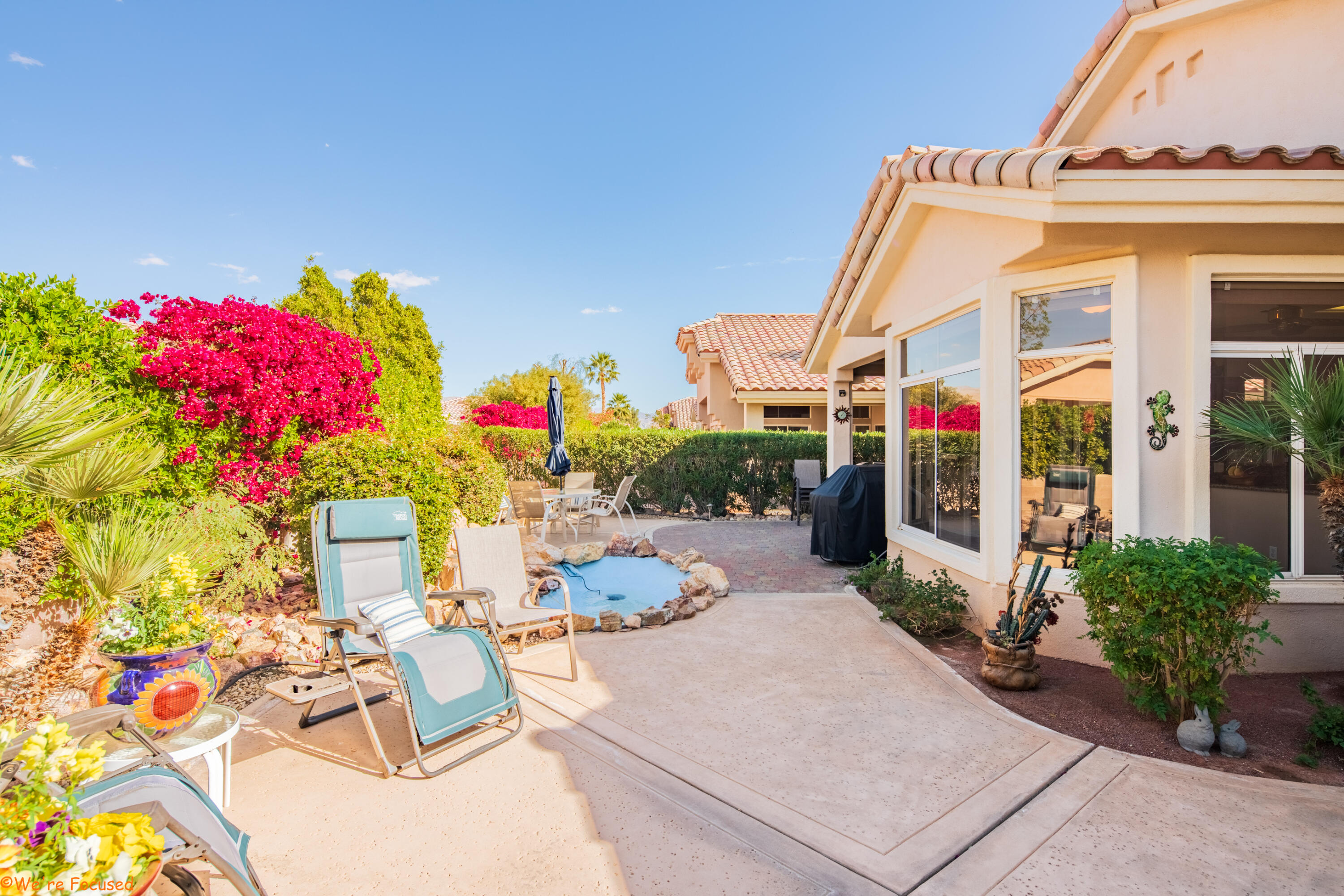 78326 Moongold Road Palm Desert, CA 92211 - Photo 29 of 33 a view of a patio with table and chairs potted plants