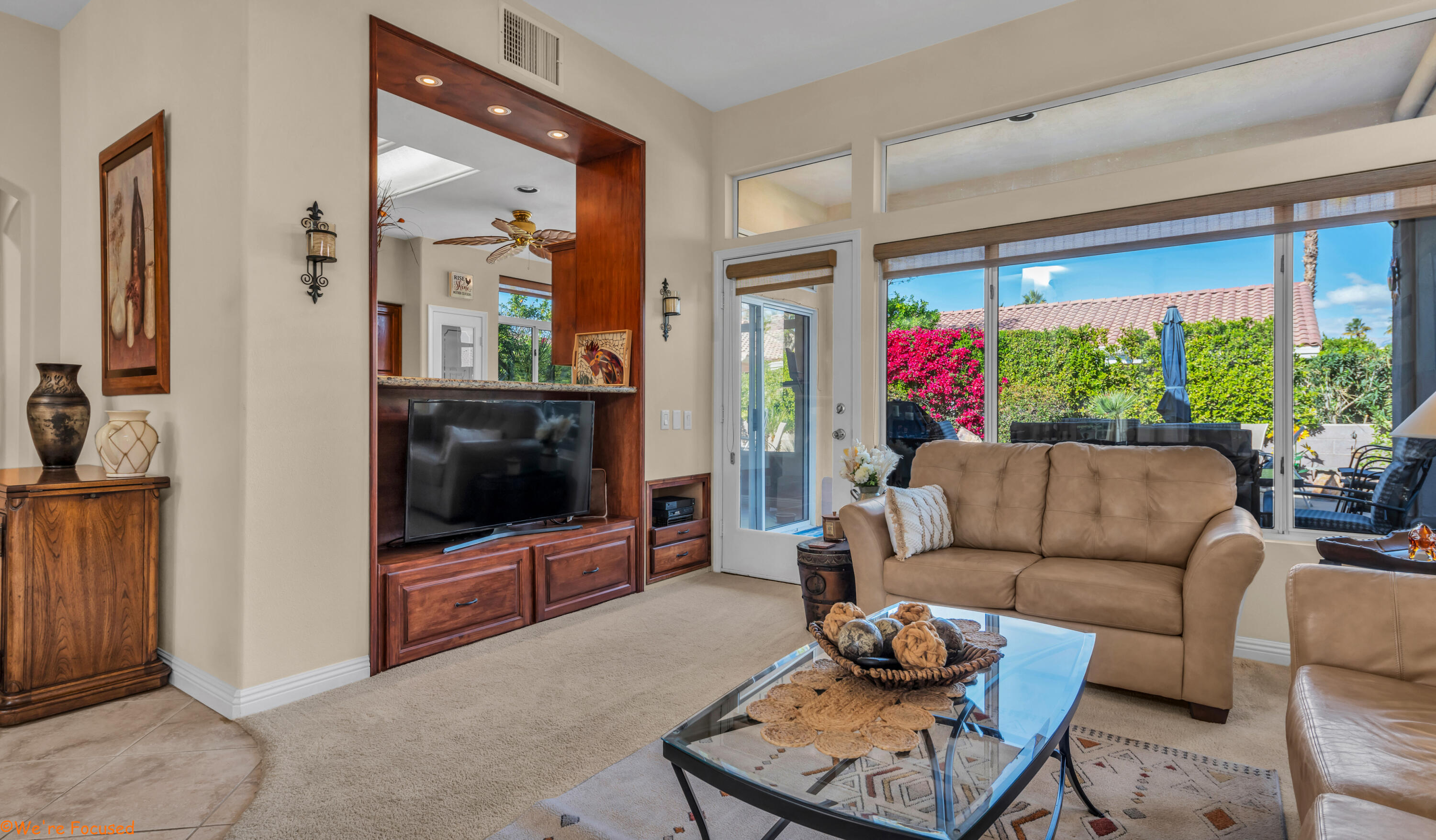 78326 Moongold Road Palm Desert, CA 92211 - Photo 4 of 33 a living room with furniture and a flat screen tv