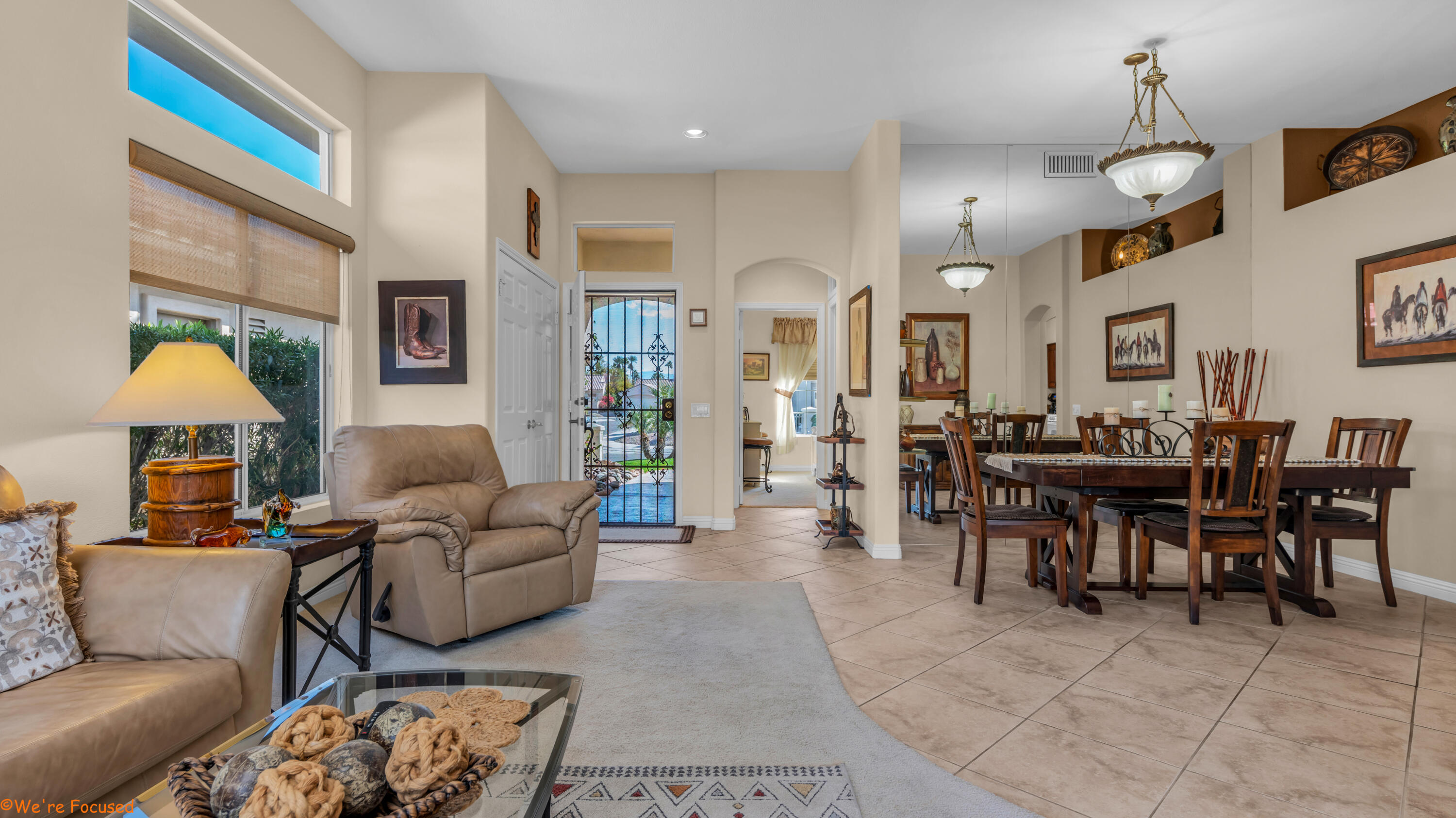 78326 Moongold Road Palm Desert, CA 92211 - Photo 6 of 33 a living room with furniture a chandelier and a dining table