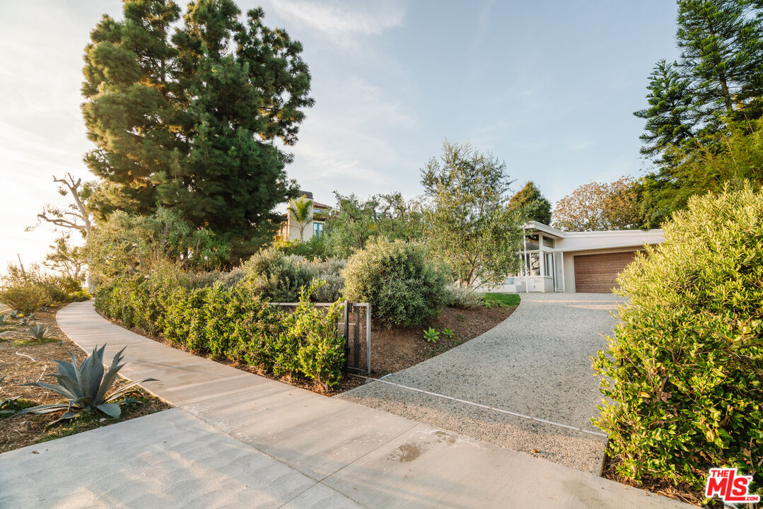 15515 Vía De Las Olas Pacific Palisades, CA 90272 - Photo 37 of 39 a view of a house with a tree and plants