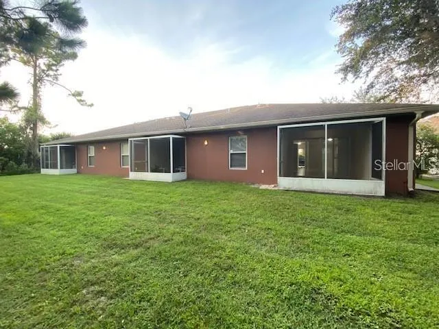 a view of a house with yard and tree s