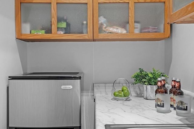 a kitchen with a refrigerator and a sink