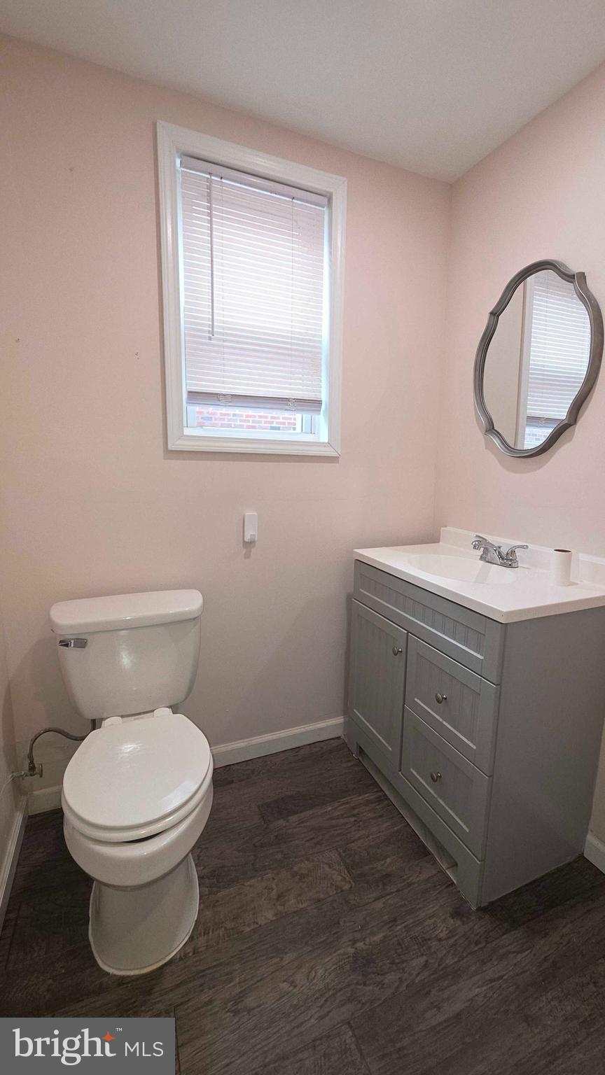 7330 Montour Street, Unit 1 Philadelphia, PA 19111 - Photo 5 of 8 a bathroom with a toilet sink vanity and mirror