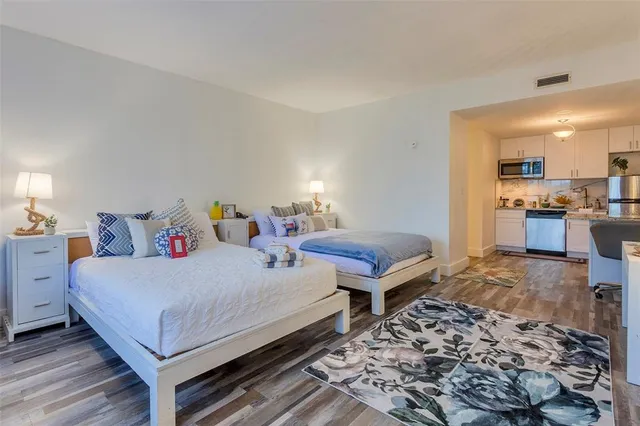 a bedroom with a bed and wooden floor