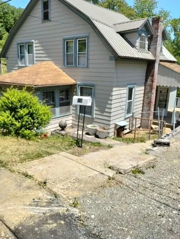 a backyard of a house with yard and outdoor seating