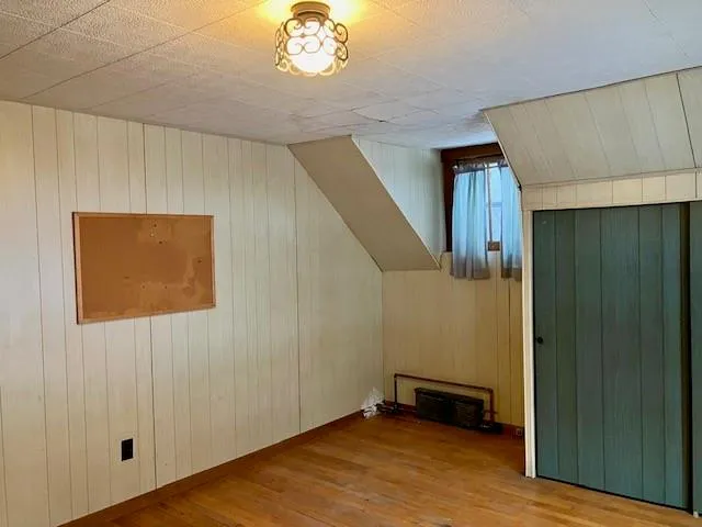 a view of a room with wooden walls