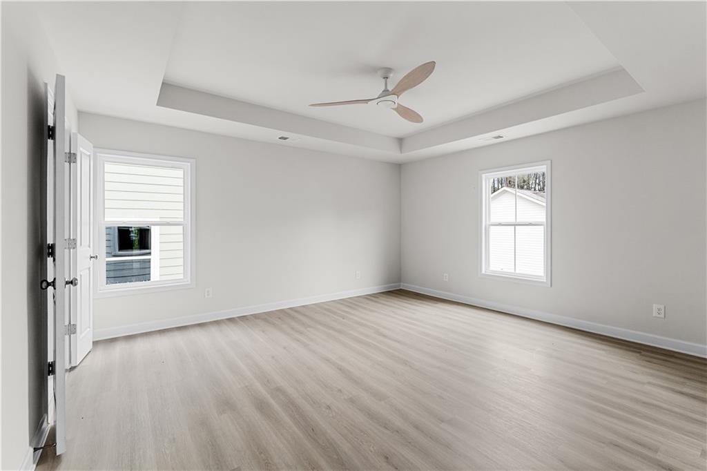 3804 Cottage Circle Clarkston, GA 30021 - Photo 4 of 9 a view of an empty room with wooden floor and a window