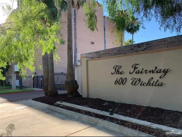 a white house that has a potted plant on it