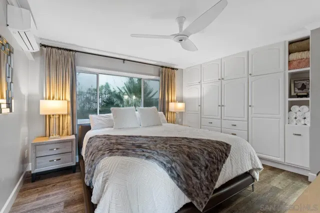 a bedroom with a large bed and a window