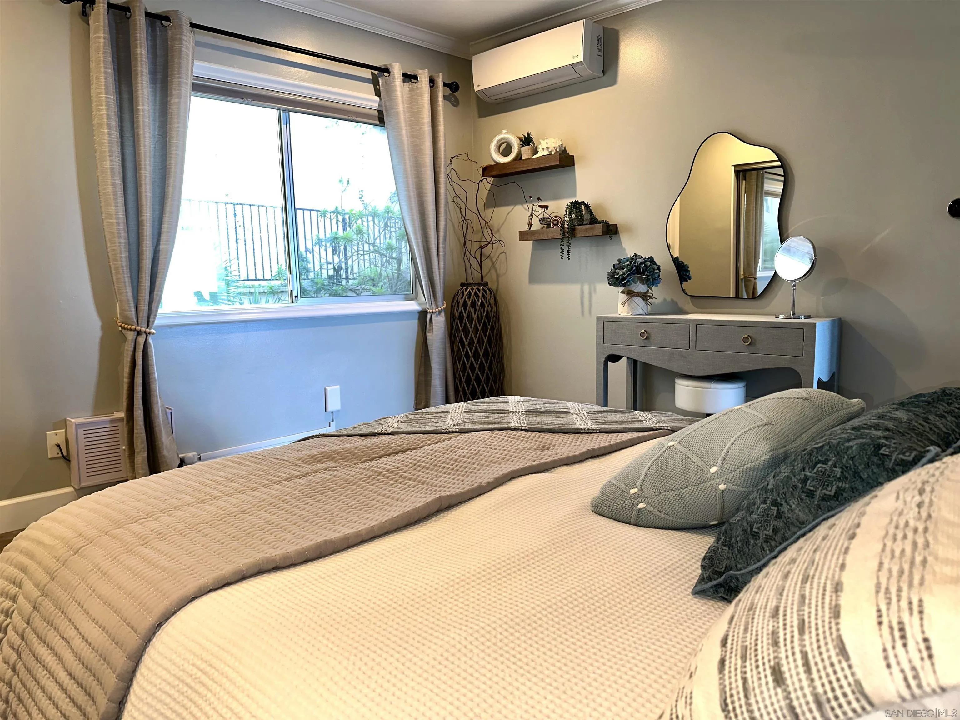 1219 Coast Boulevard, Unit 4 La Jolla, CA 92037 - Photo 12 of 16 a bedroom with a bed dresser and mirror