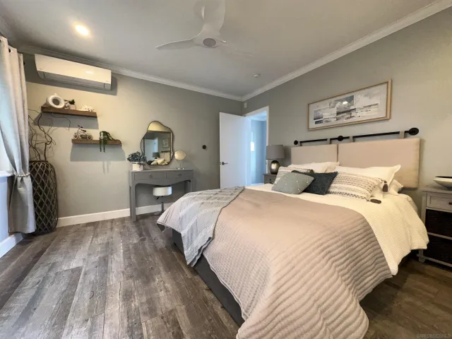a bedroom with a bed and a large mirror
