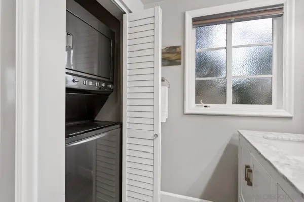 a bathroom with a granite countertop window and a sink