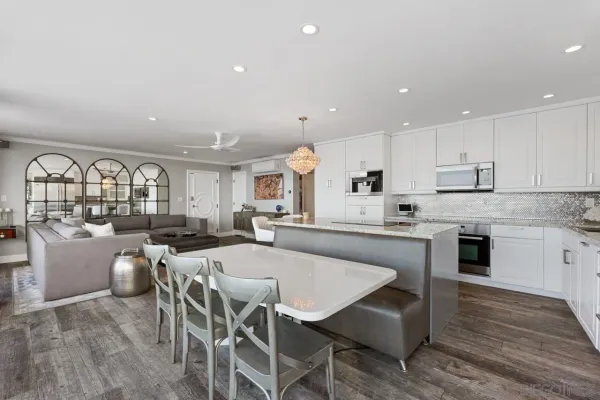a large kitchen with a table and chairs