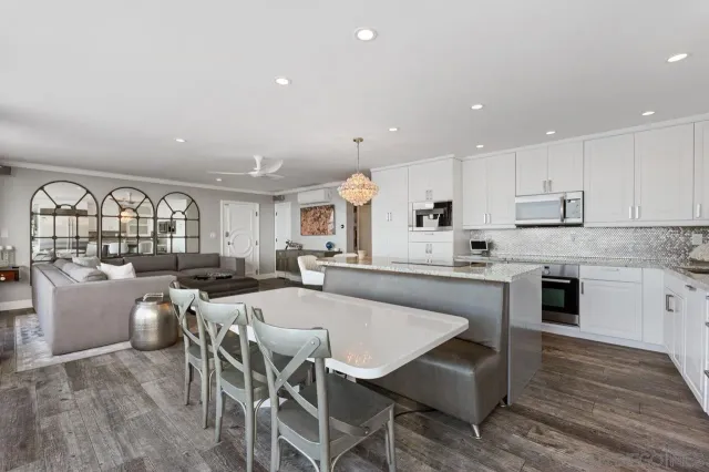 a large kitchen with a table and chairs