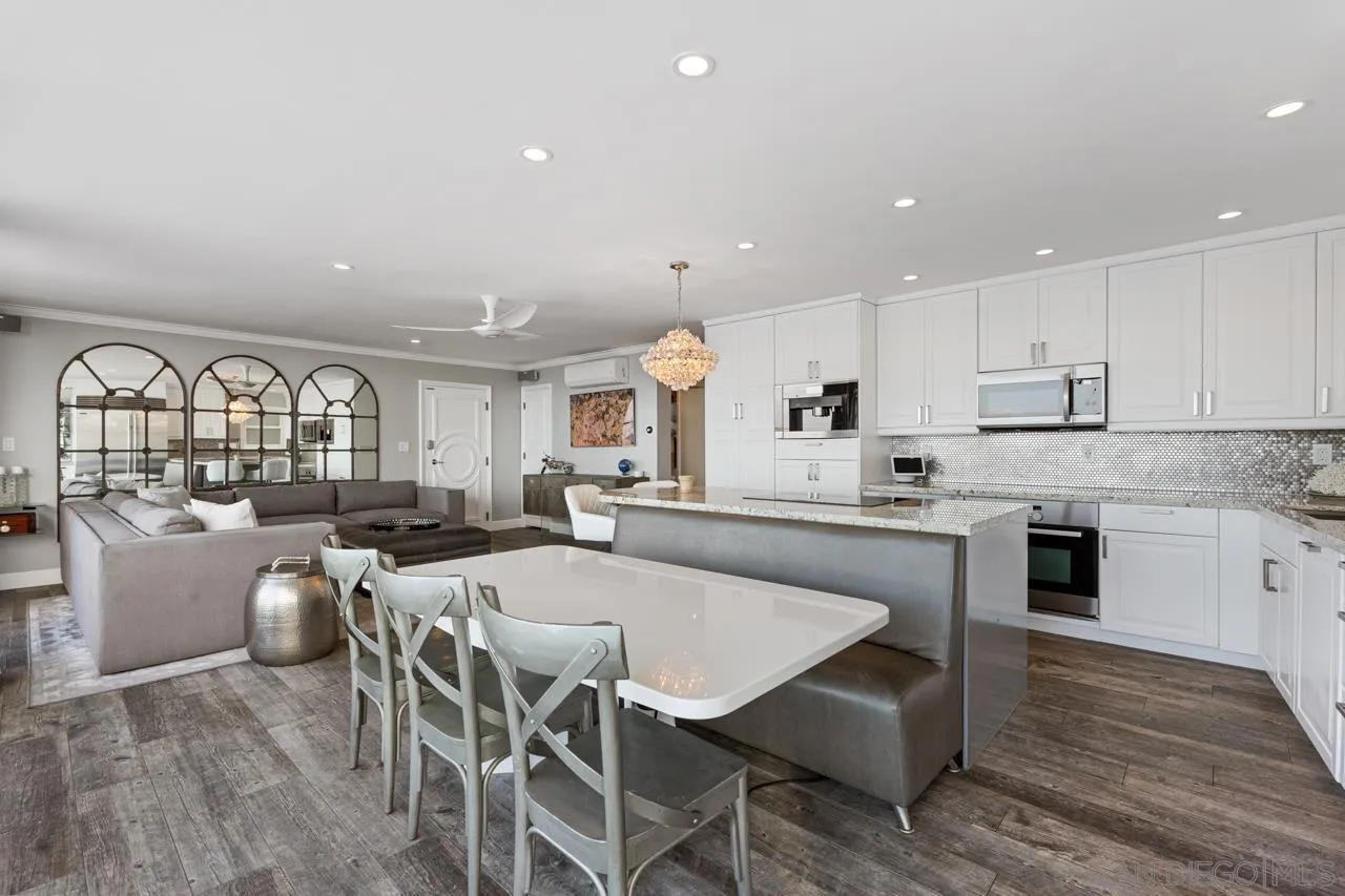 1219 Coast Boulevard, Unit 4 La Jolla, CA 92037 - Photo 9 of 16 a large kitchen with a table and chairs