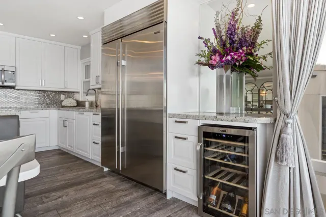 a kitchen with a refrigerator and a stove
