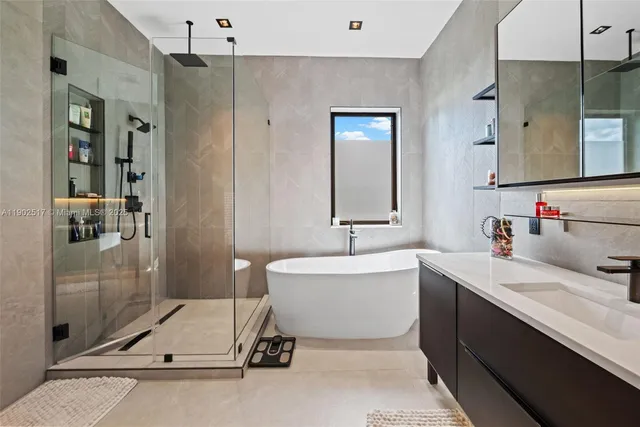 a en suite bathroom with a double vanity sink a mirror and shower