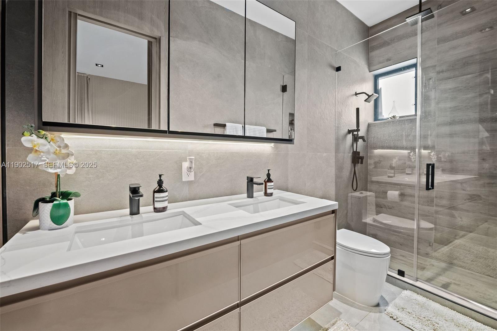 655 Layne Boulevard Hallandale Beach, FL 33009 - Photo 19 of 46 a bathroom with a sink a toilet and shower