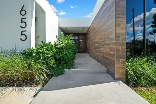 a view of a pathway along with potted plants