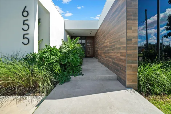 a view of a pathway along with potted plants