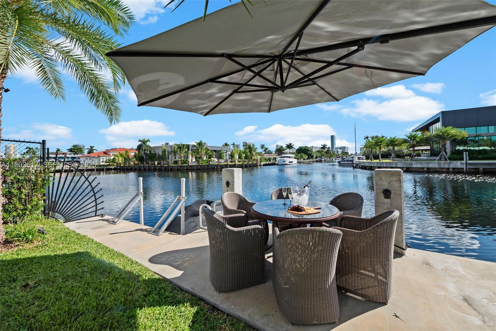 655 Layne Boulevard Hallandale Beach, FL 33009 - Photo 33 of 46 a view of a lake with a table and a chairs