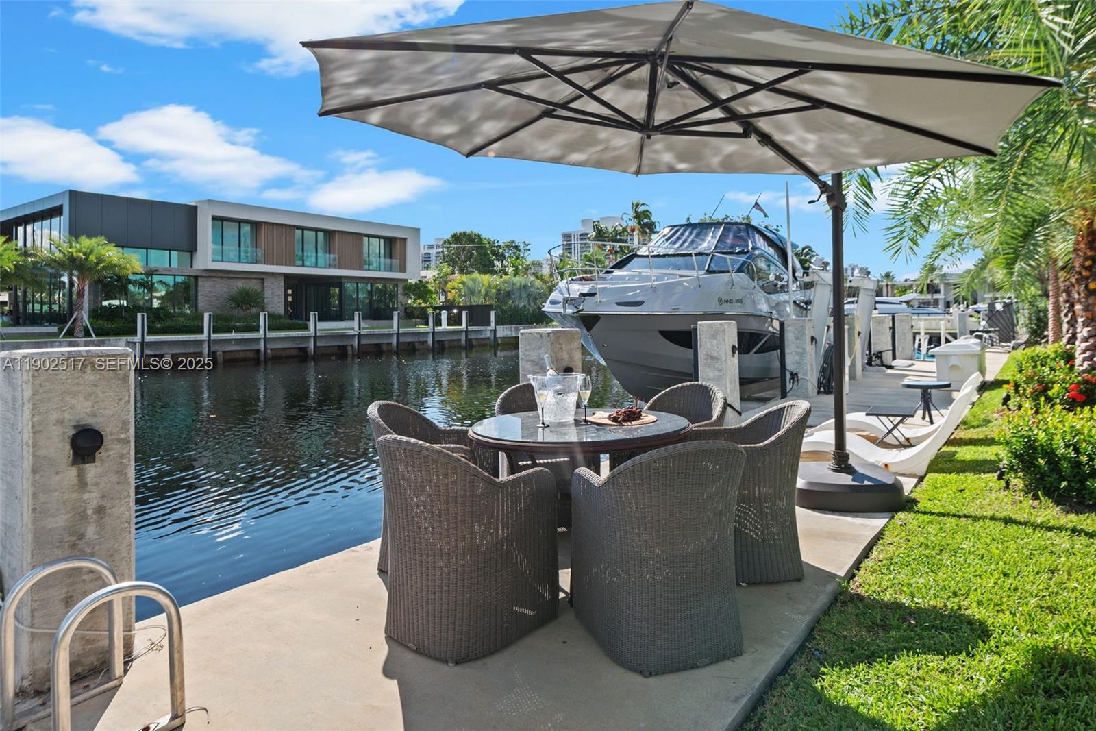 655 Layne Boulevard Hallandale Beach, FL 33009 - Photo 34 of 46 a view of a table and chairs under an umbrella in a patio