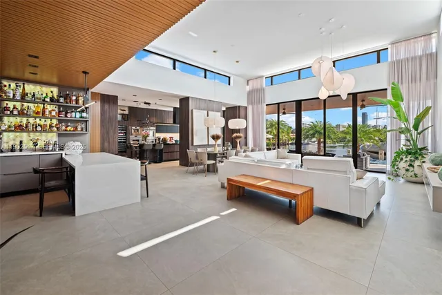 a living room with fireplace furniture and a large window