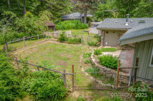 a backyard of a house with table and chairs