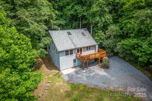 an aerial view of a house with backyard space and balcony
