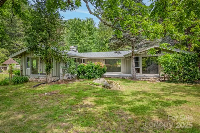 a view of a house with a backyard