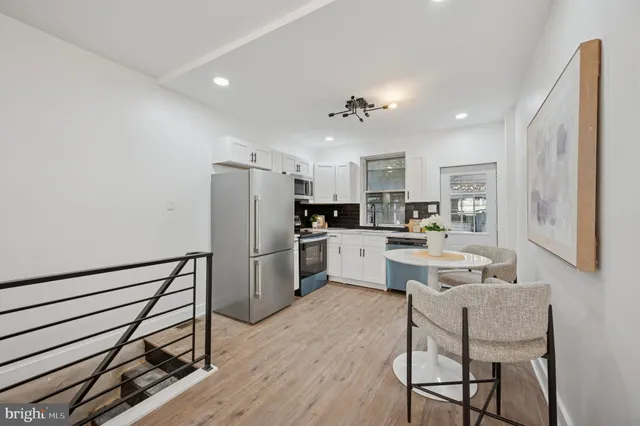 a kitchen with stainless steel appliances granite countertop a refrigerator stove microwave and sink