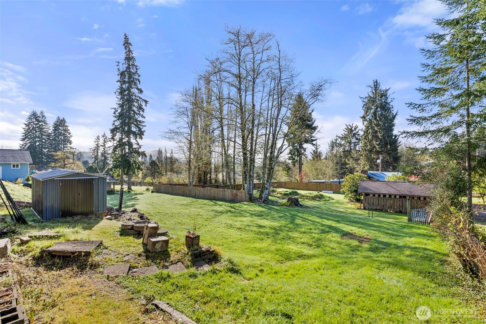 3306 Romane Road Raymond, WA 98577 - Photo 22 of 25 a view of a chair and fire pit in the backyard of a house