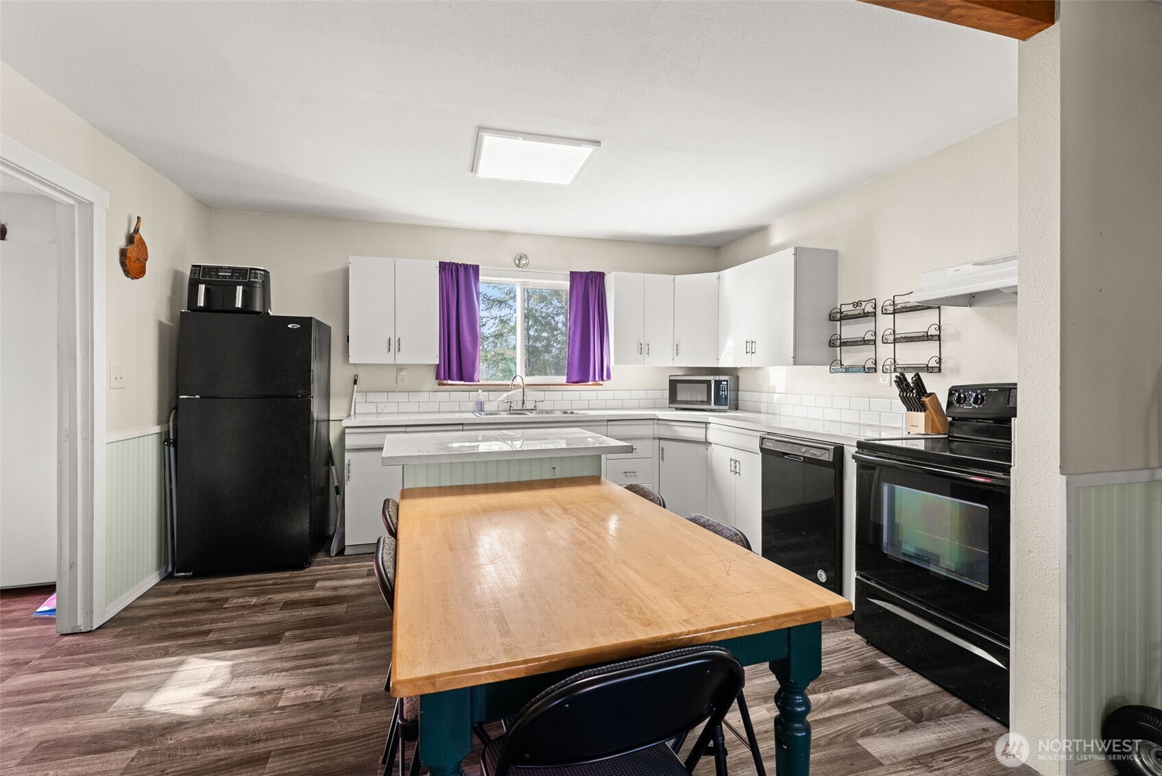 3306 Romane Road Raymond, WA 98577 - Photo 9 of 25 a kitchen with a refrigerator a stove a sink and a microwave