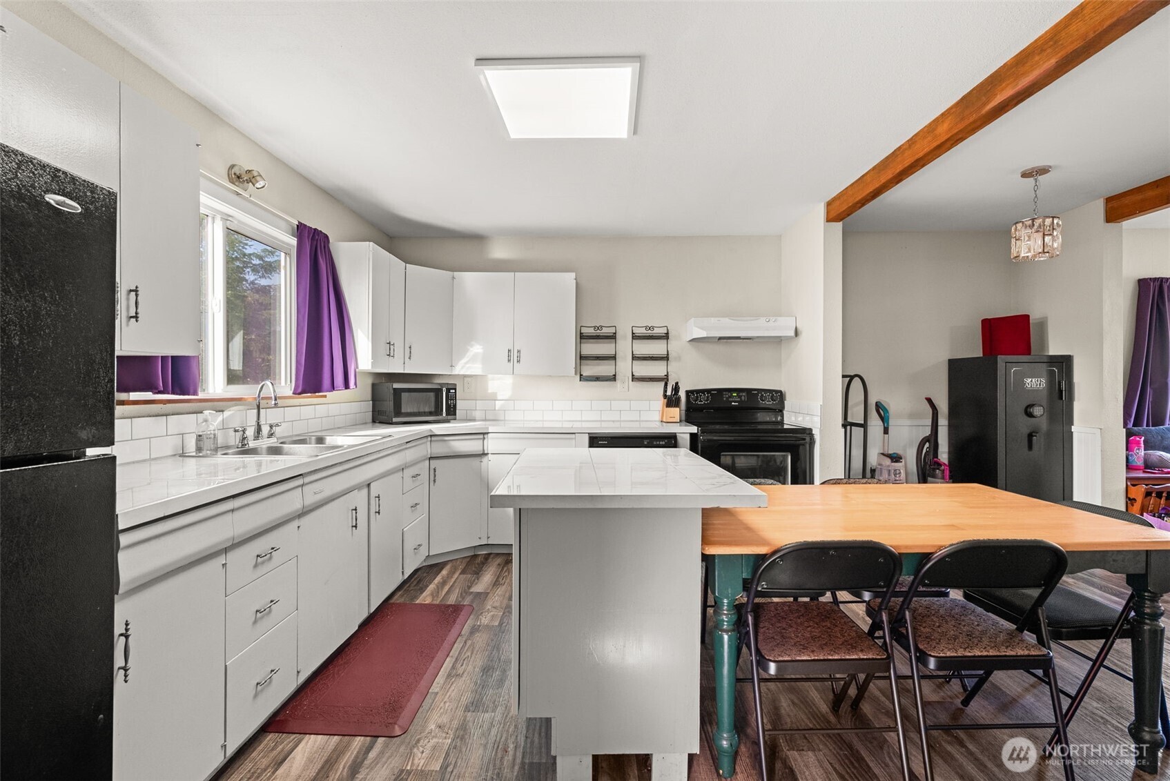 3306 Romane Road Raymond, WA 98577 - Photo 10 of 25 a large kitchen with a table and chairs