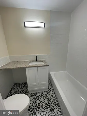 a bathroom with a bathtub and a sink
