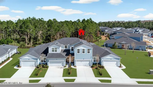 a aerial view of a house with swimming pool garden and patio