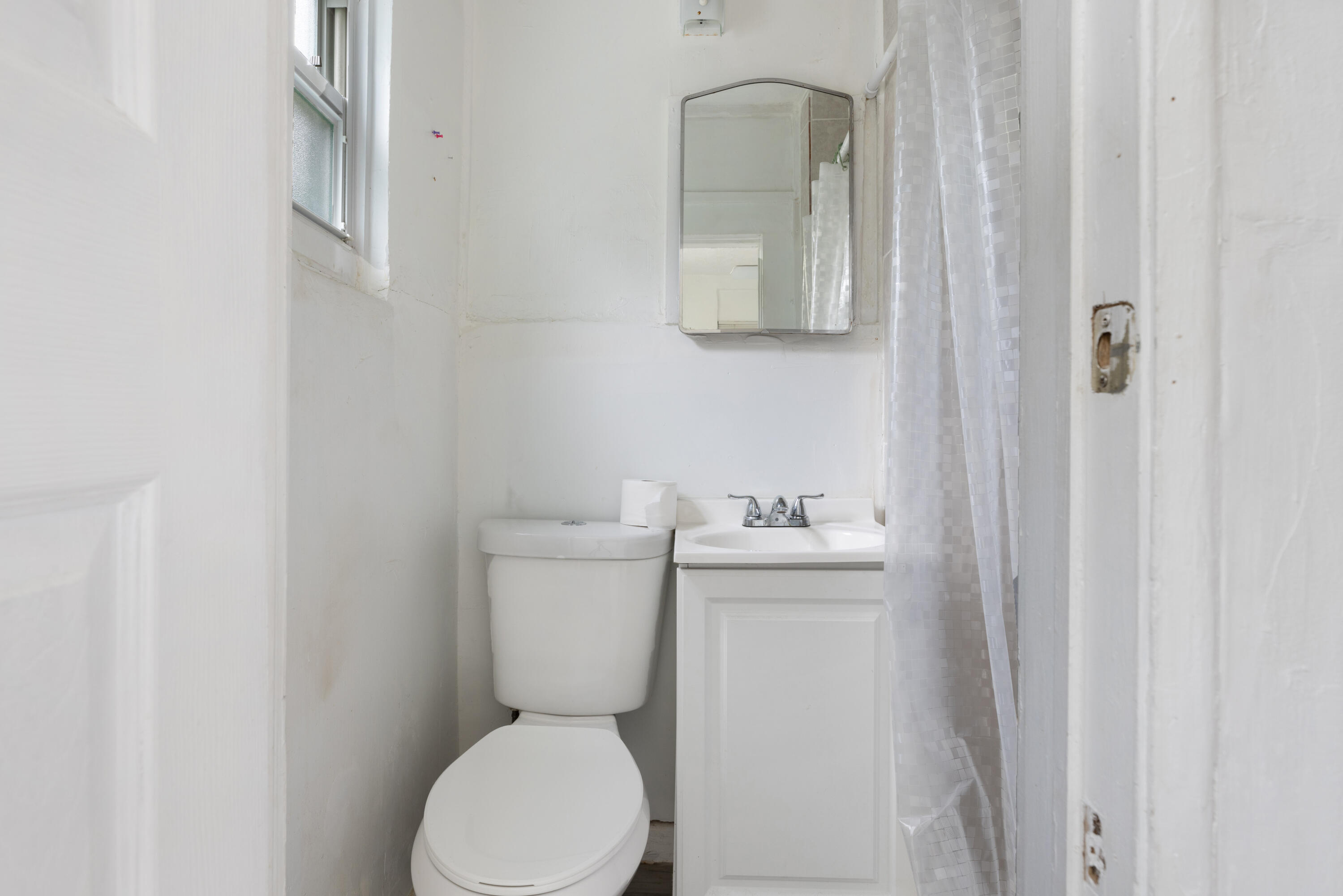 902 Boston Avenue Fort Pierce, FL 34950 - Photo 11 of 34 a white toilet sitting next to a bathroom sink