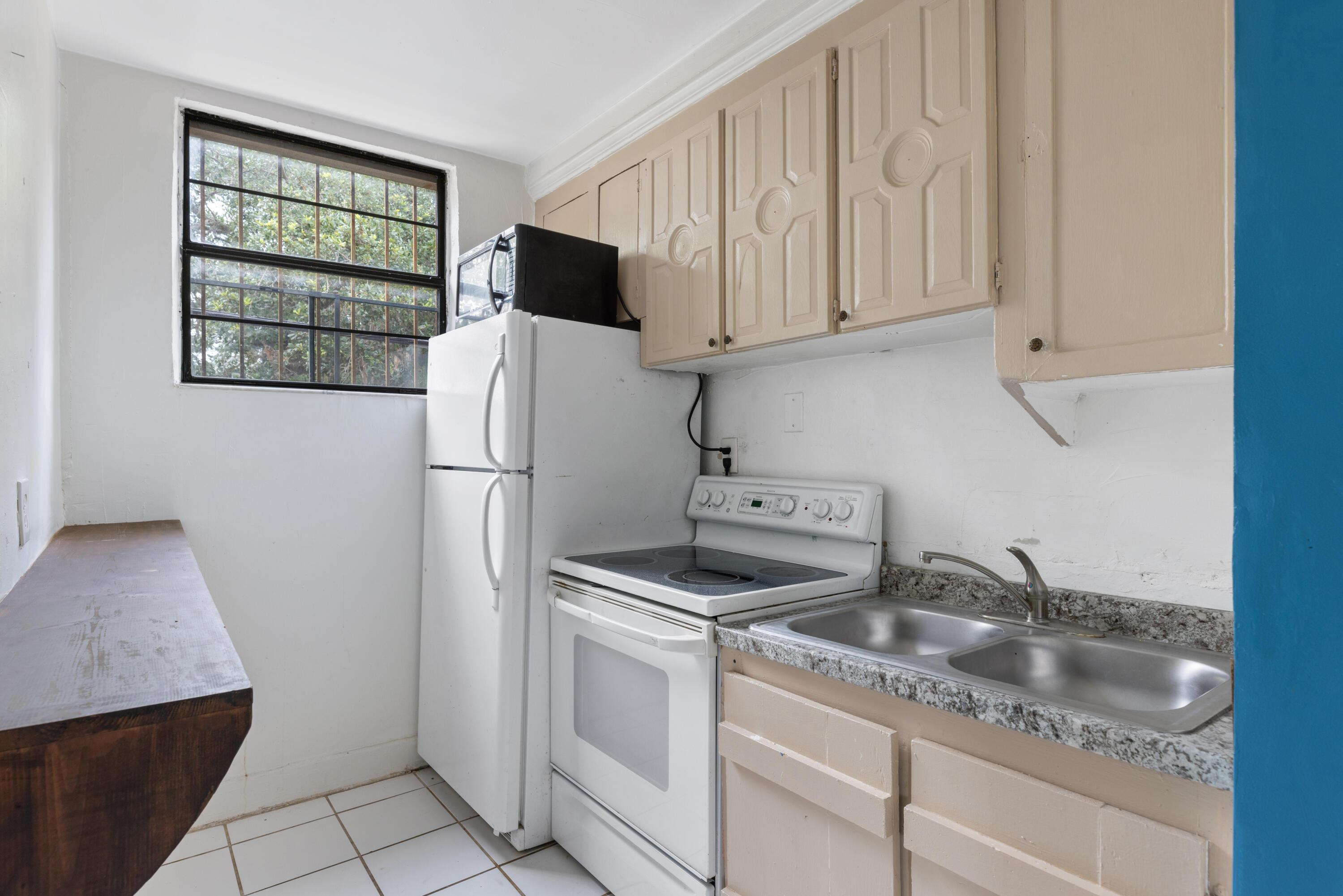 902 Boston Avenue Fort Pierce, FL 34950 - Photo 13 of 34 a kitchen with stainless steel appliances granite countertop a refrigerator sink and cabinets