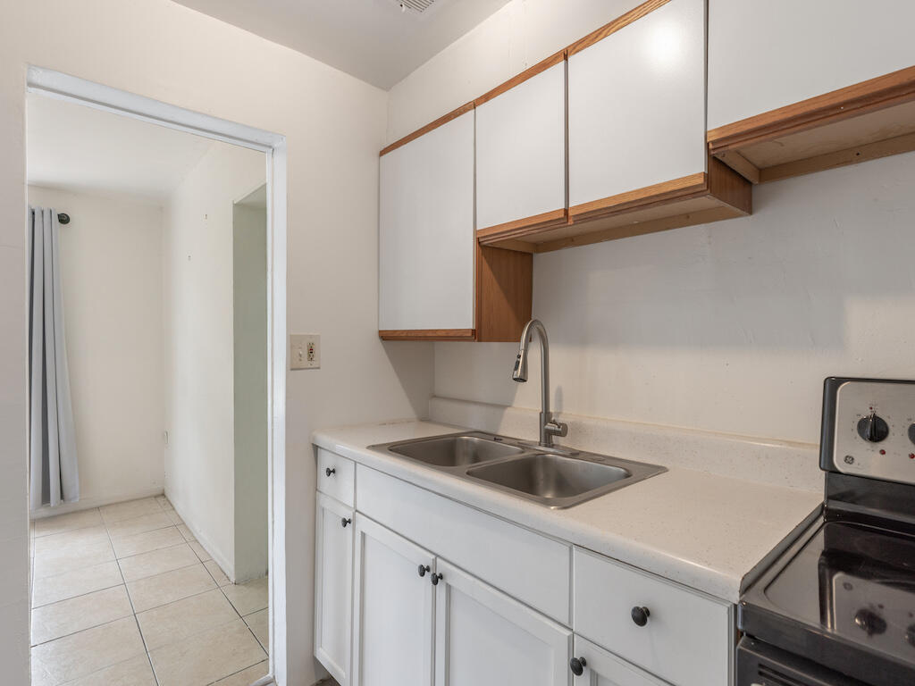 902 Boston Avenue Fort Pierce, FL 34950 - Photo 21 of 34 a kitchen with stainless steel appliances granite countertop a sink and cabinets