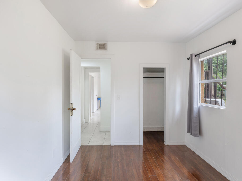 902 Boston Avenue Fort Pierce, FL 34950 - Photo 27 of 34 a view of a hallway with wooden floor and closet