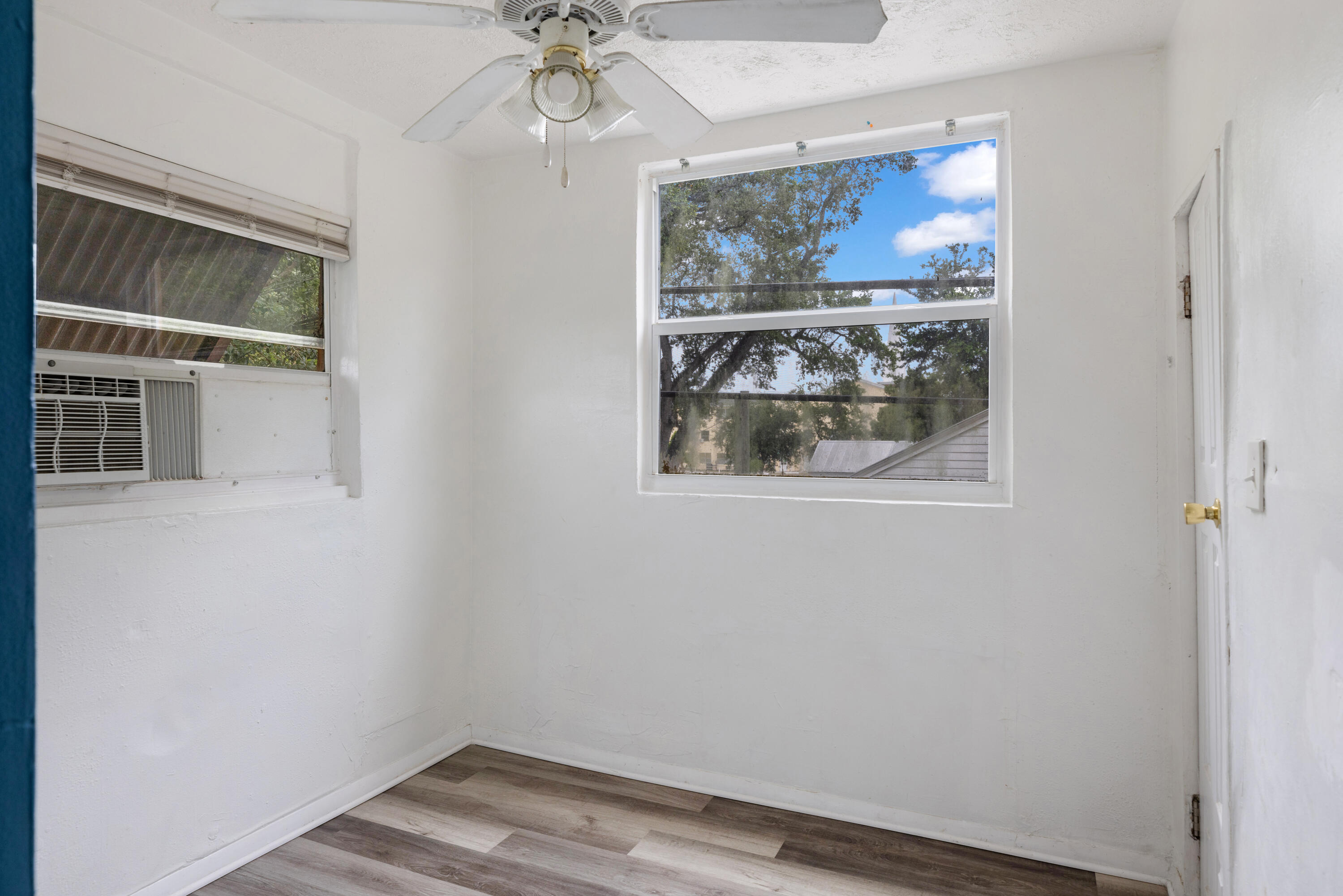 902 Boston Avenue Fort Pierce, FL 34950 - Photo 9 of 34 a view of a livingroom with wooden floor and chandelier