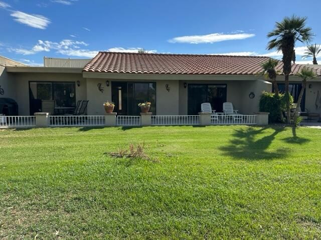 a view of a house with sitting area and swimming pool