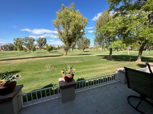 a view of lawn chairs and iron fence