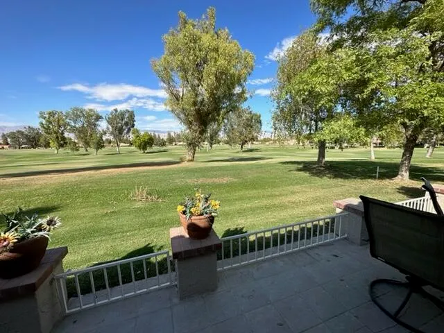 a view of lawn chairs and iron fence
