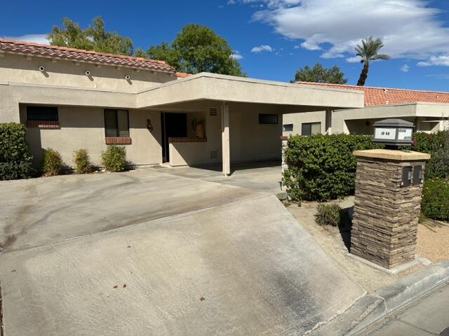 41450 Inverness Way Palm Desert, CA 92211 - Photo 19 of 19 a front view of a house with a yard and garage
