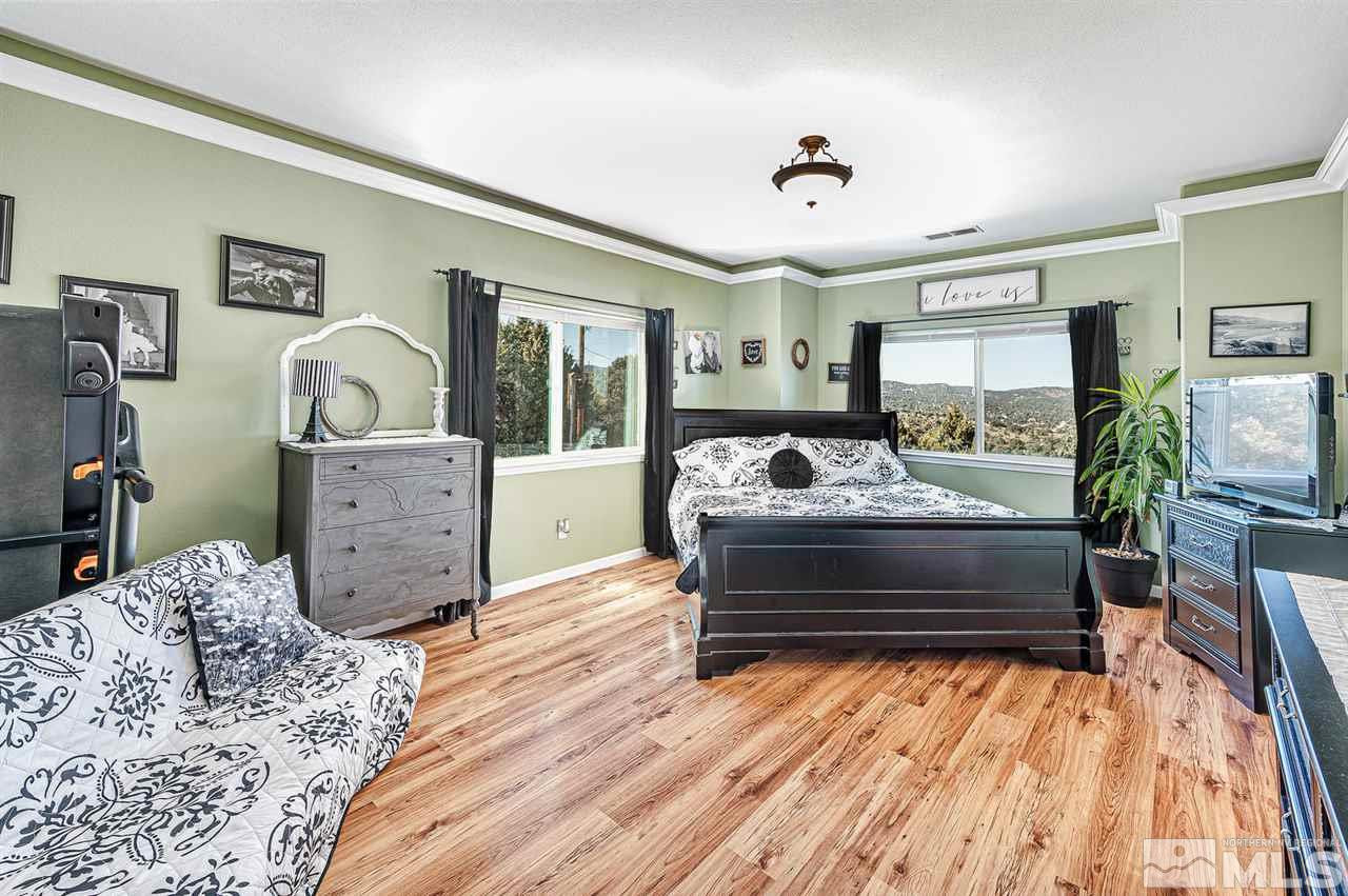 3650 Palisade Road Reno, NV 89521 - Photo 13 of 25 a bedroom with a bed window and flat screen tv