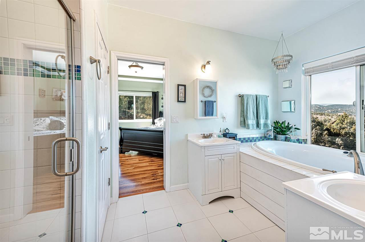 3650 Palisade Road Reno, NV 89521 - Photo 15 of 25 a bathroom with a tub sink and mirror